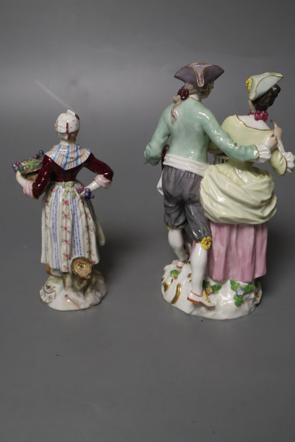 A Meissen group of a gardener and companion and a Meissen figure of a fruit seller, tallest 15cm (2)